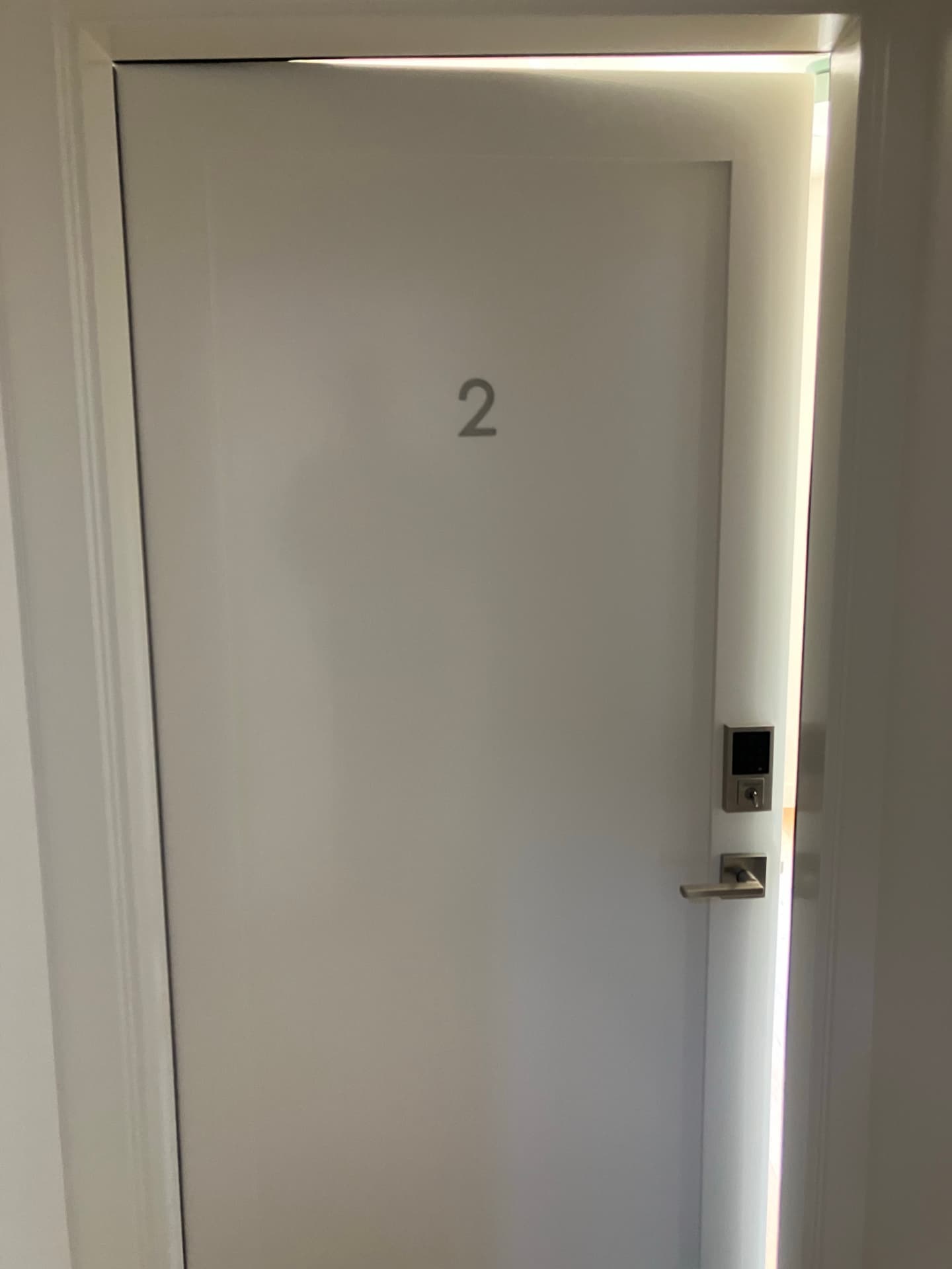 Unit 2 front door marked with the number 2 and a keypad lock