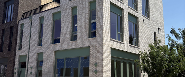 The 1640 Spoke Street building in the Wheeler District, whitewashed brick with sage green trim